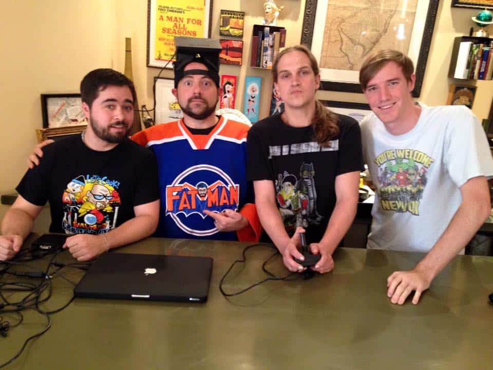 Group of four young men at a gaming event, smiling and posing for the camera.