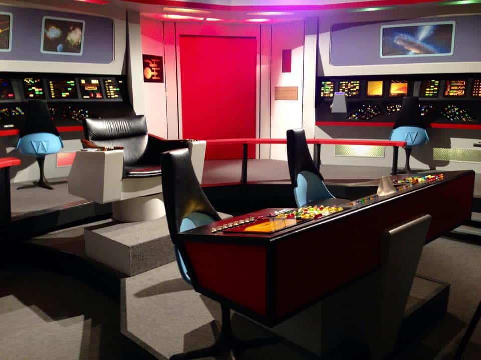 Starship bridge control room with advanced navigation consoles and seating.