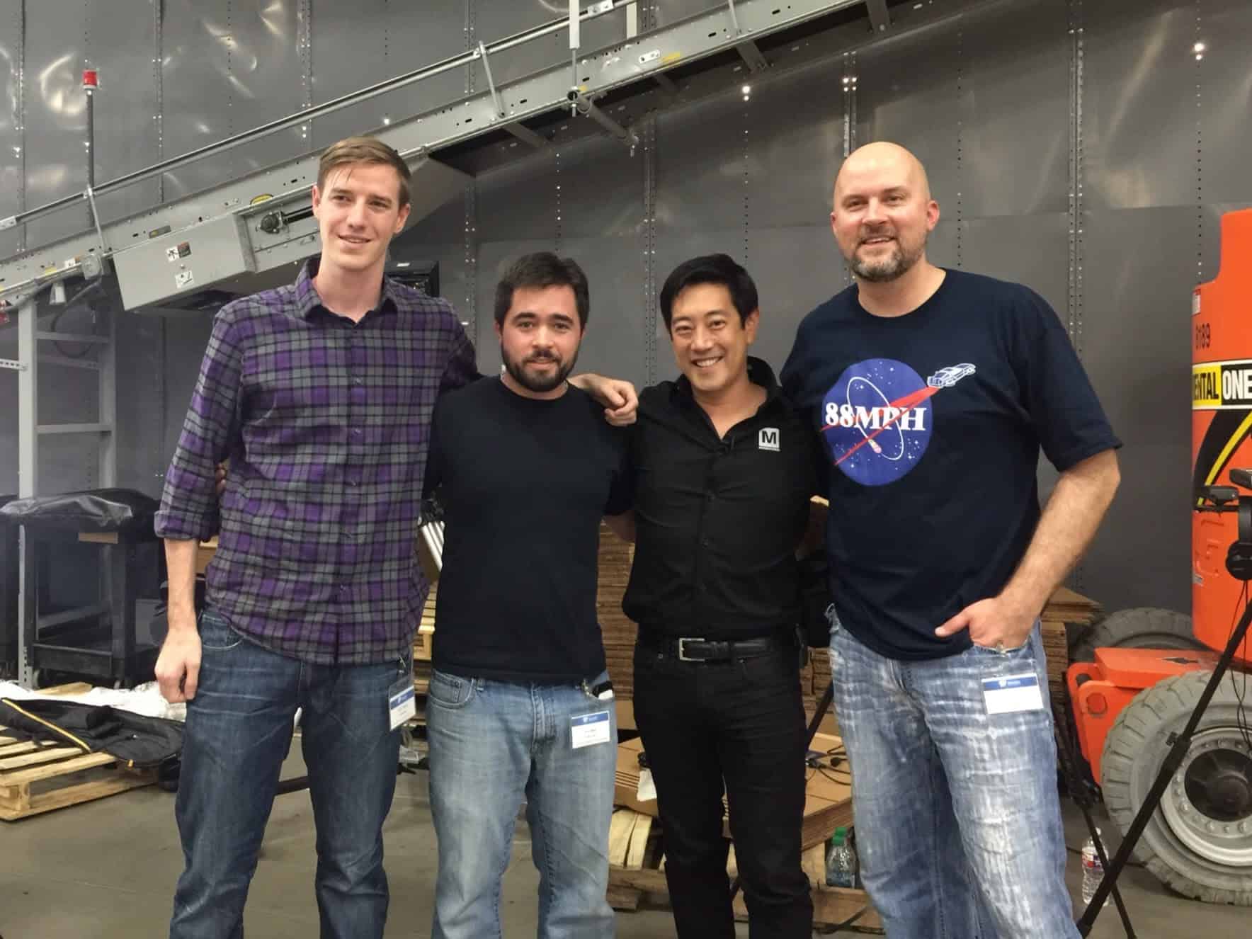 Group of four diverse professionals in a tech workspace at Metzae.net.