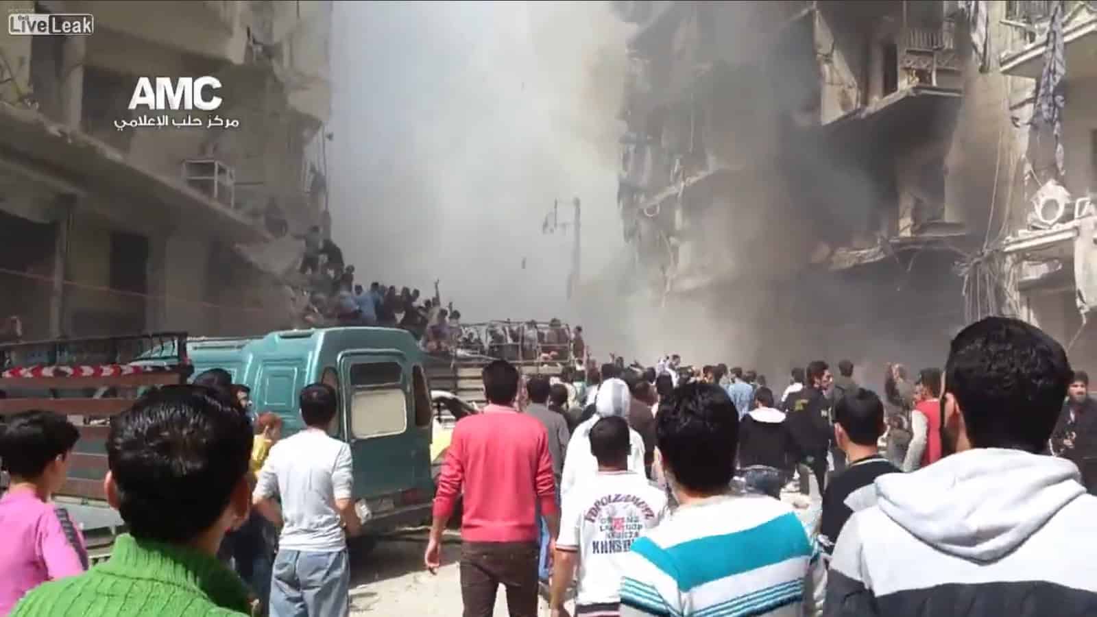 Explosion in urban street with smoke and crowd, emergency response scene.
